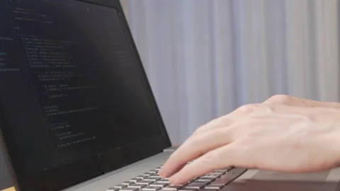 Programmer Writes Program Code. A Professional Developer Debugs The Program. Clo Stock Footage 132634054