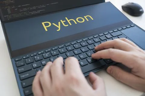 Programmer writes a program in python. Male hands on a black keyboard Stock Photos