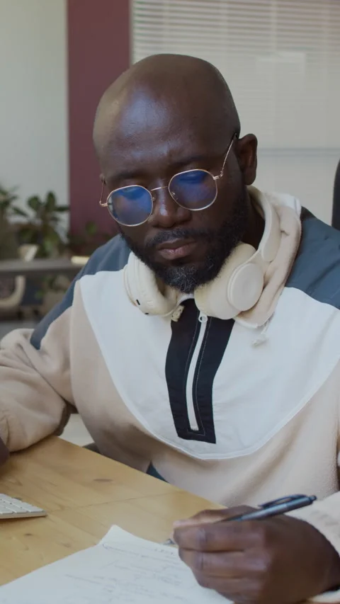 Programmer Writing Algorithm in Notebook while Working on Computer Stock Footage 293931847