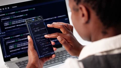 Programmer Writing Code On Laptop And Phone Stock Footage 312890663