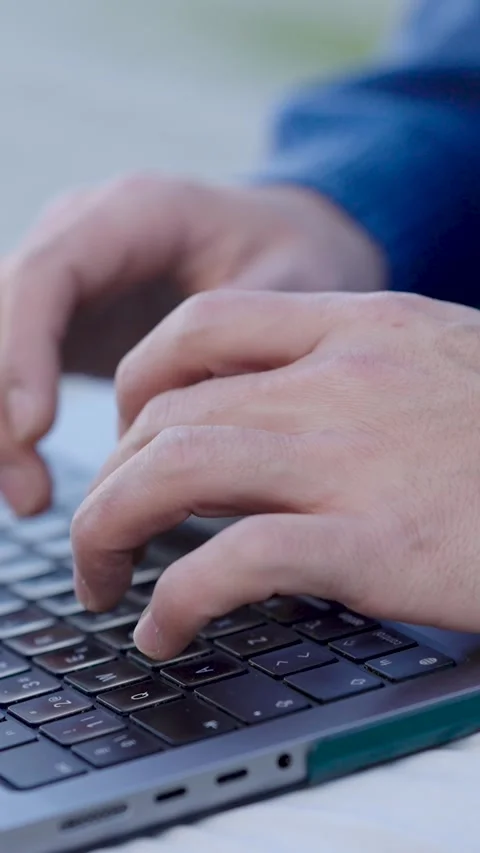 Programmer writing code on laptop keyboard. Vertical Video stock 302730542