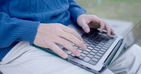 Programmer writing code outdoors on laptop Stock-Footage 301698633