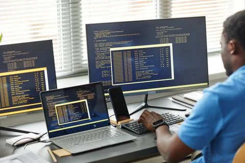 Programmer writing codes on computer at office Stock-Fotos
