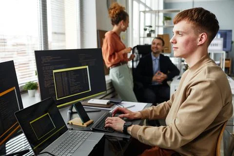 Programmer writing codes on computer at table Stock Photos