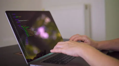 A programmer is writing program code on the laptop. Stock Footage 202053902