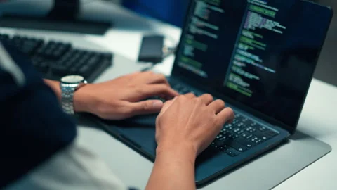 Programmer writing source code on laptop for software development Stock Footage 313808576
