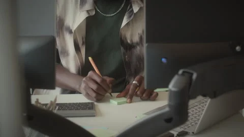 Programmer Writing Sticky Note and Working on Computer in Office Stock Footage 263733563
