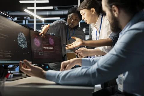 Programmers in AI data center react to virus alert, protecting critical systems Stock Photos