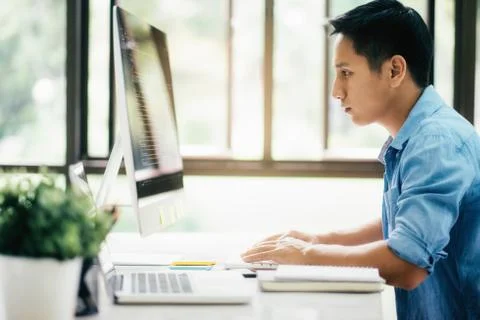 Programmers and developer teams are coding and developing software Stock Photos