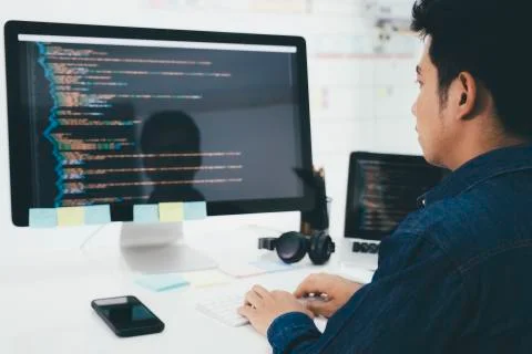 Programmers and developer teams are coding and developing software Stock Photos