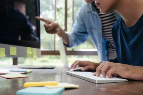 Programmers and developer teams are coding and developing software Stock Photos