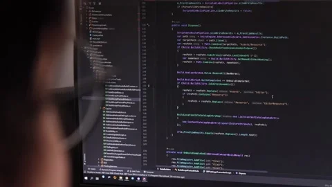 Programmer's code on the monitor. the programmer works at the computer. Stock Footage 219565017