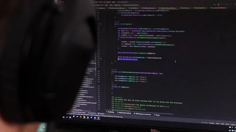 Programmer's code on the monitor. the programmer works at the computer. A man in Stock Footage 219565019