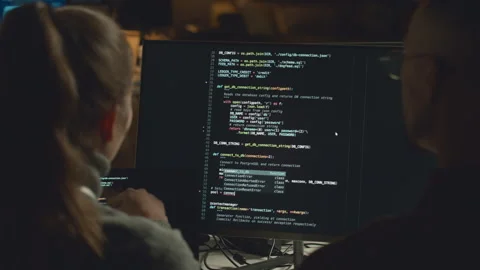 Programmers Coding on Computer at Night Stock Footage 259157056