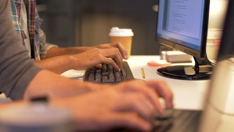 Programmers with coffee working at computers Stock Footage 88047607
