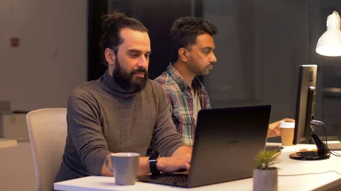 Programmers with coffee working at computers Stock Footage 88047695