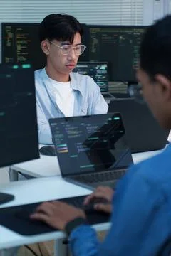 Programmers Collaborating on Digital Code and AI Development Stockfoto's