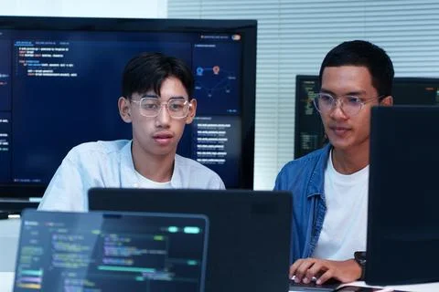 Programmers Collaborating on Digital Software Development Foto stock
