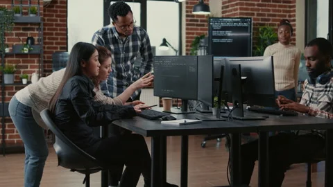 Programmers collaborating on group project compiling algorithm for new cloud Video stock 168237222