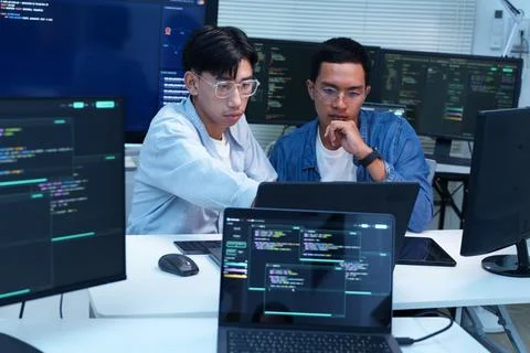 Programmers Collaborating on Software Development and AI Code Stock Photos
