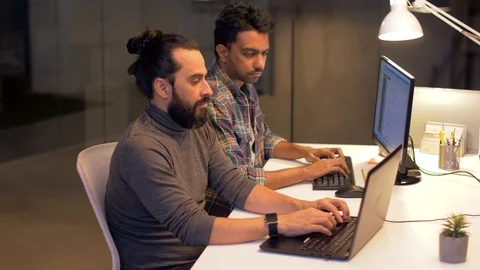 Programmers with computers working late at office Stock-Footage 88145135