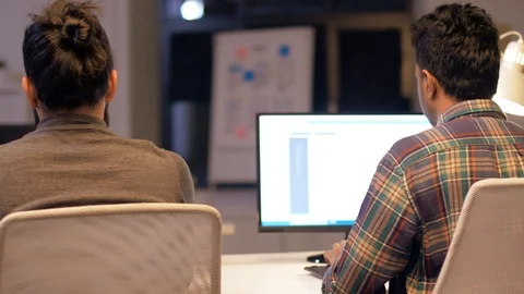 Programmers with computers working late at office Stock Footage 88145385