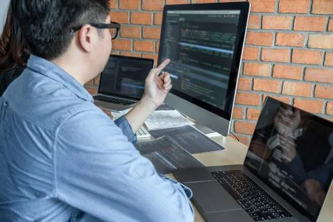 Programmers cooperating at Developing programming and website working in a so Stock-Fotos