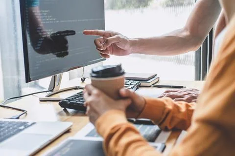 Programmers cooperating at Developing programming and website working in a .. Stock Photos
