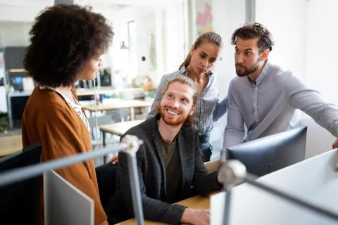 Programmers cooperating at IT company developing apps Stock-Fotos