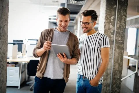 Programmers cooperating at IT company developing apps Stock-Fotos