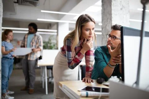 Programmers cooperating at IT company developing apps Stock Photos