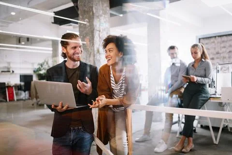 Programmers cooperating at IT company developing apps Stock-Fotos