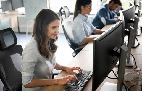 Programmers cooperating at IT company developing apps Stock-Fotos