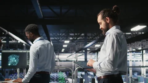 Programmers on data center industrial platform checking code on tablet Video stock 310277976