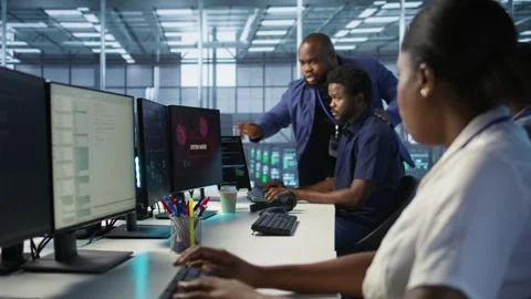 Programmers in data center office doing teamwork to delete virus Stock Footage 319538240