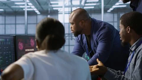 Programmers in data center office doing teamwork to delete virus Stock-Fotos