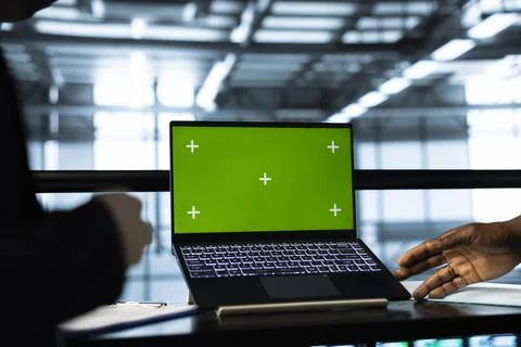 Programmers in data center using mockup laptop, inspecting server rigs 写真素材
