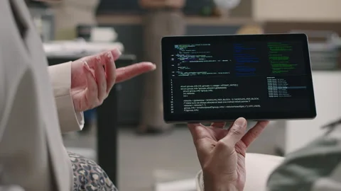 Programmers Discussing Codes on Digital Tablet in Office Stock Footage 274336556