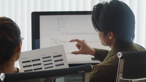 Programmers Discussing Tasks of Software Developing Project at Office Stock-Footage 256977189