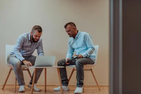 Programmers engrossed in deep collaboration, diligently working together to 스톡 사진
