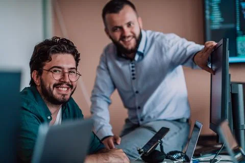 Programmers engrossed in deep collaboration, diligently working together to 스톡 사진