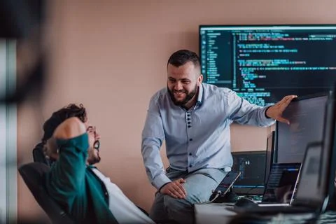 Programmers engrossed in deep collaboration, diligently working together to Stock Photos
