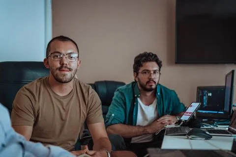 Programmers engrossed in deep collaboration, diligently working together to 스톡 사진