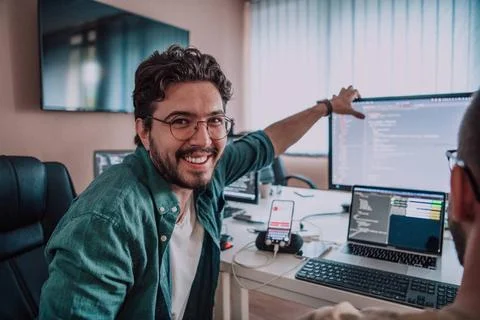 Programmers engrossed in deep collaboration, diligently working together t... Stock-Fotos