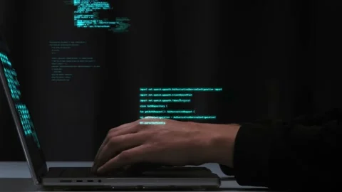 Programmer's fingers quickly type computer code on the laptop keyboard. Neon Stock Footage 227922827