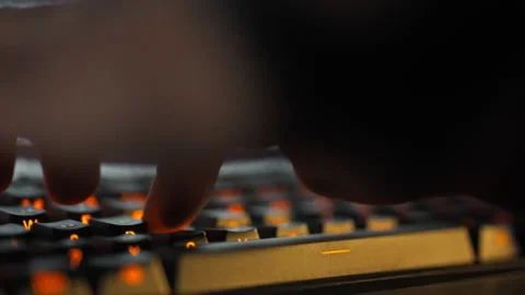 A programmers fingers swiftly type coding sequences on a computer keyboard g Stock Footage 331314737