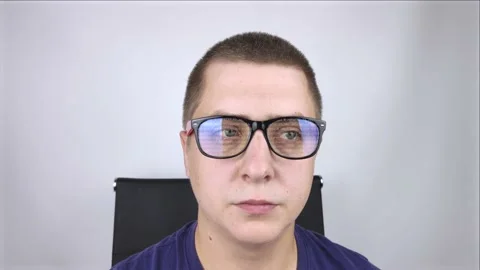 The programmer's glasses reflect moving lines of code. Programming, development  Stock Footage 138362986