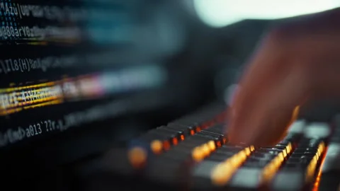 A programmers hand swiftly presses computer keyboard keys crafting code disp Stock Footage 331458973