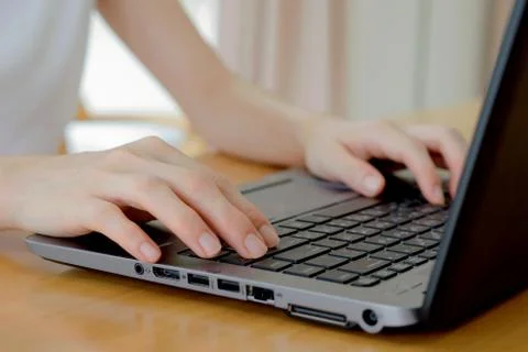 Programmer's hand typing with laptop. focus on his finger Stock Photos