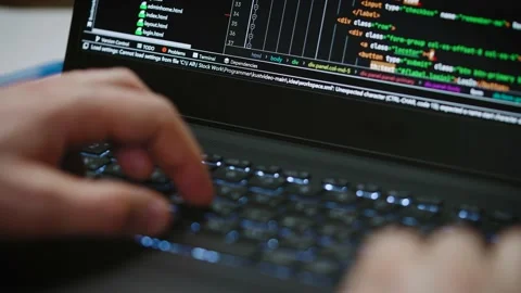Programmer's hands and laptop keyboard close-up. Working on a project on a Stock Footage 174864314